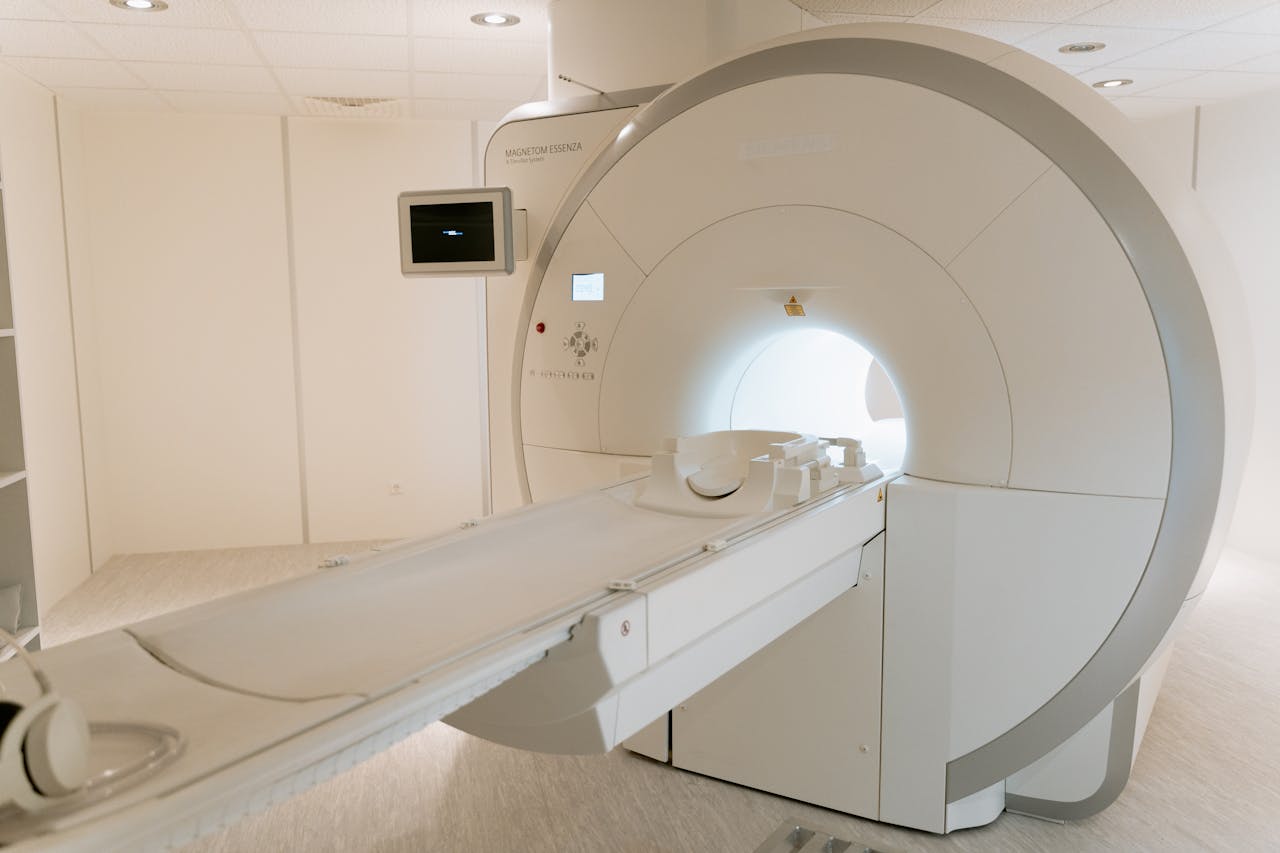 A state-of-the-art MRI scanner in a well-lit hospital room, ready for patient use.